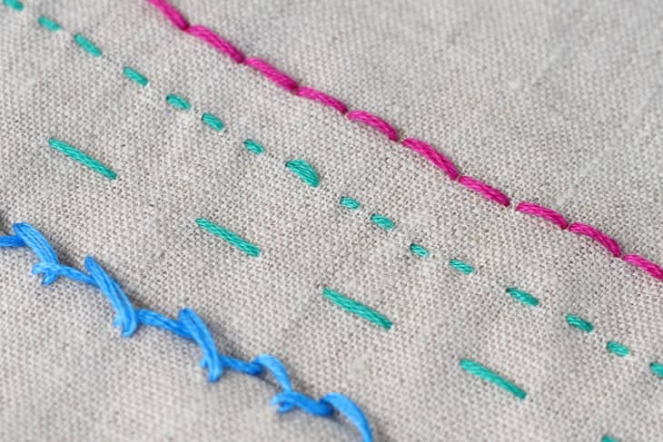 pink thread, green thread, and blue thread running stitches