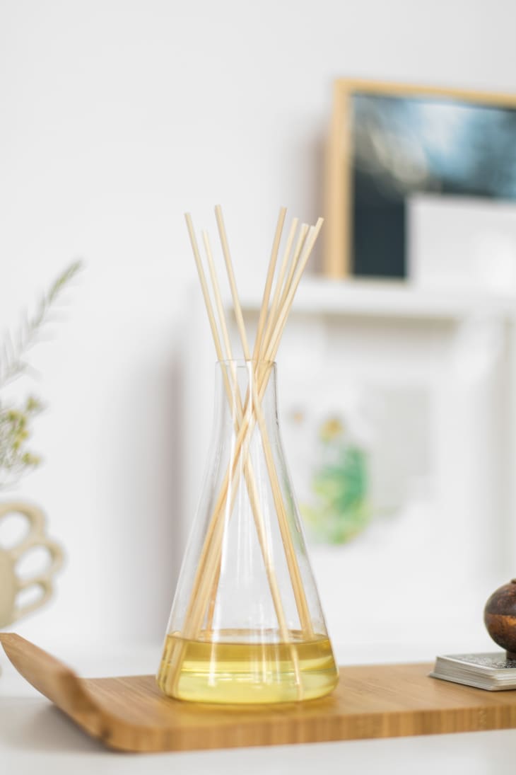 DIY oil-based reed diffuser on wooden tray