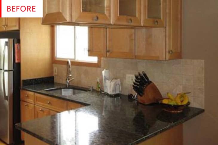 Before: black countertops surrounded by light wood cabinets in a basic kitchen