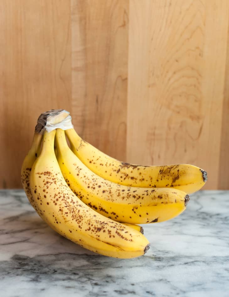 bunch of ripe bananas on marble countertop