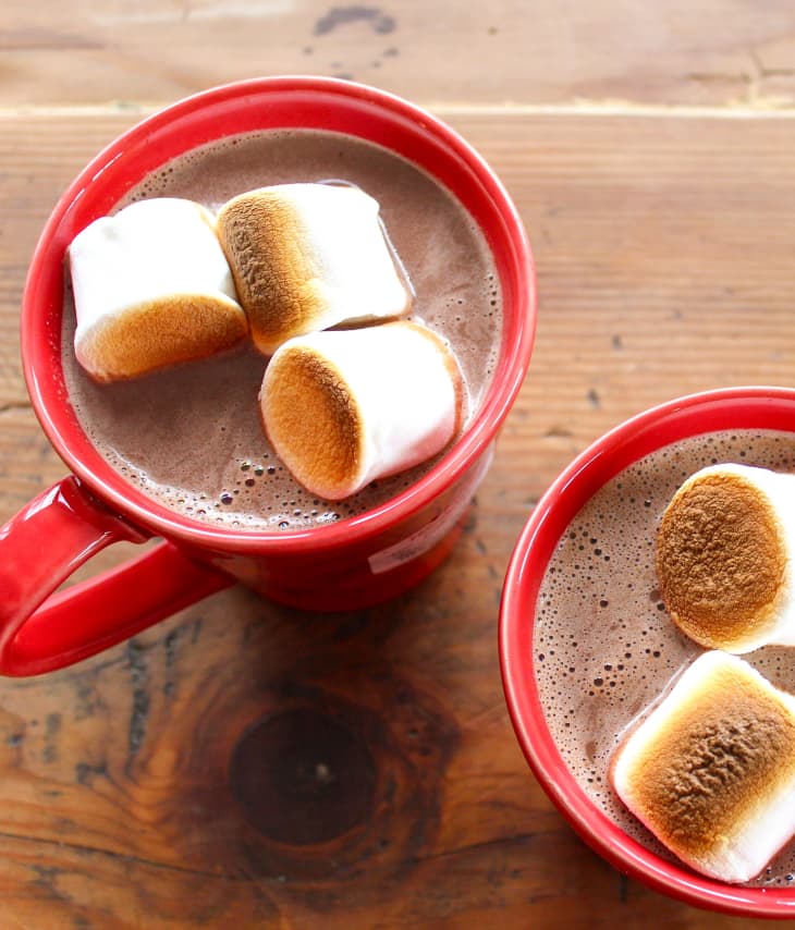 Hot cocoa topped with marshmallows in a red mug