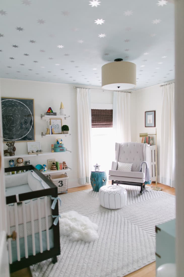 Nursery with celestial gray and silver wallpapered ceiling