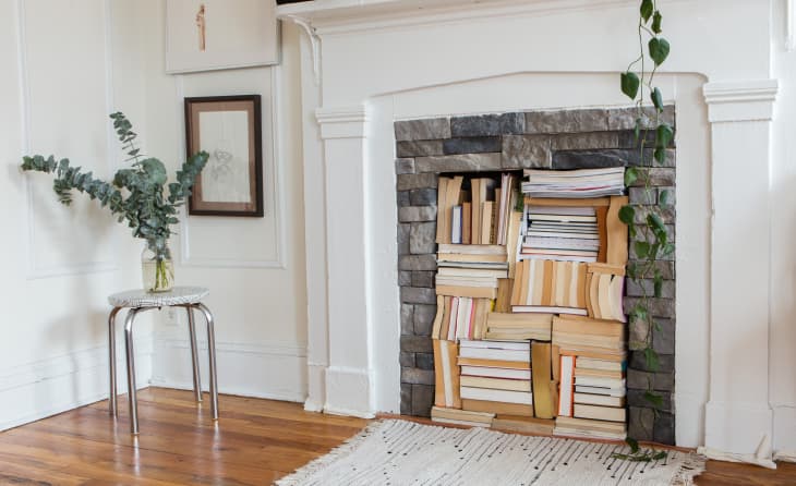 Books are stored inside a fireplace