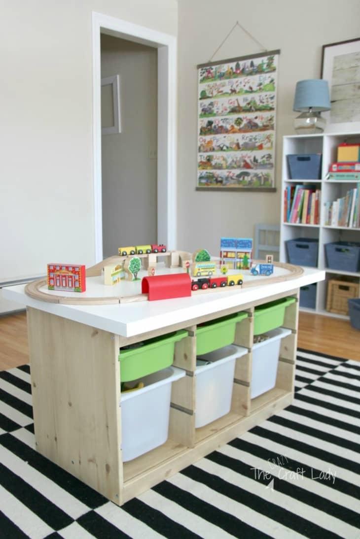 A train table is fashioned out of this Trofast unit, becoming the focal point of the playroom