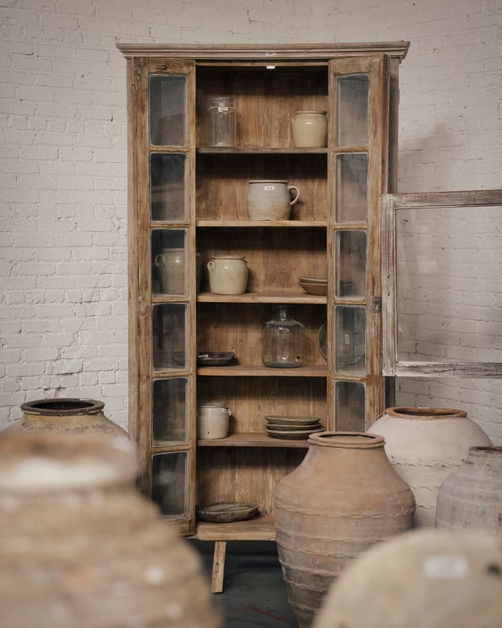 Ceramic jugs and vases by Olive Ateliers. Cabinet with more vessels in background