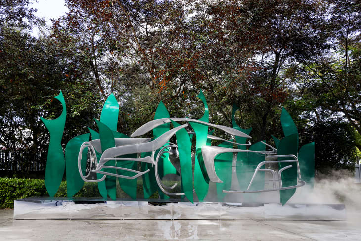 Green and silver metal large outdoor sculpture, designed by Suchi Reddy. Shaped by Air
