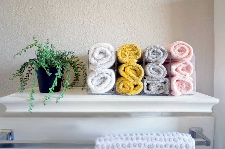 colorful washcloths arranged on bathroom shelf