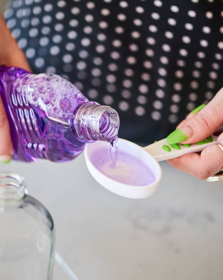 measuring out fabuloso to make spray