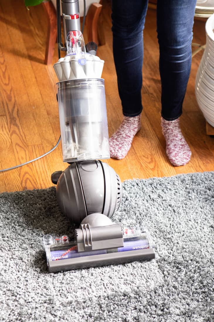 Vacuuming area of the rug after removing the wax