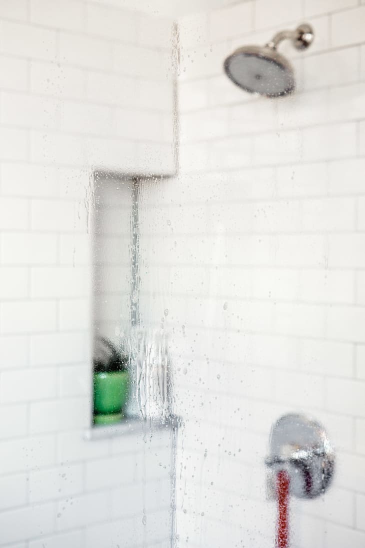 Shower door covered in cleaning solution, letting it sit