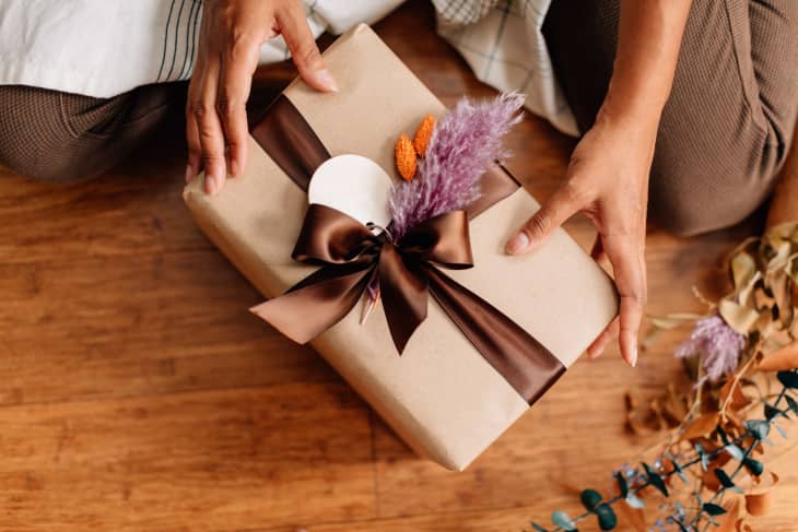 Pretty wrapped present in brown paper, brown ribbon, dried flowers