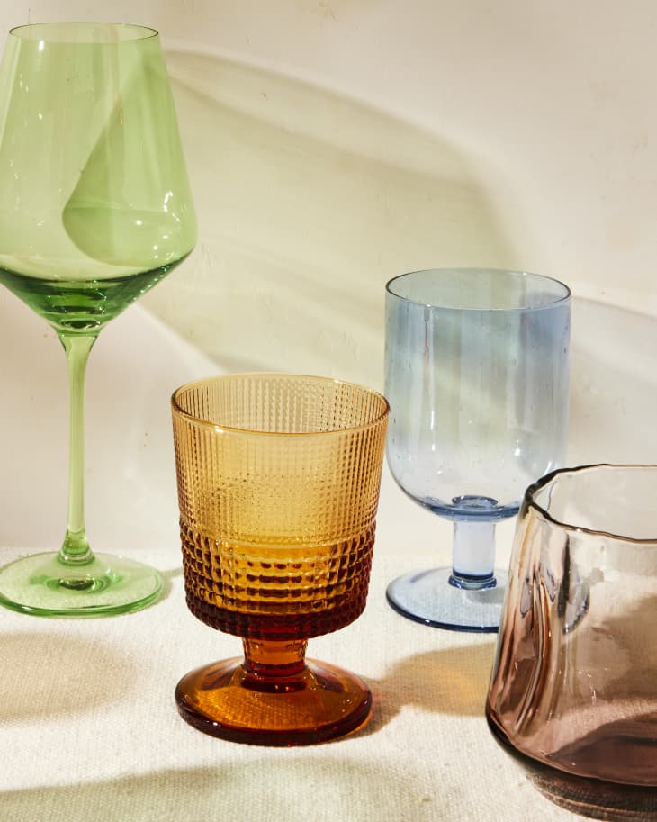 Colorful glasses on linen casting colorful shadows