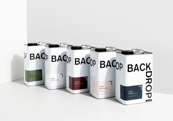Five cans of Backdrop wall paint in various colors