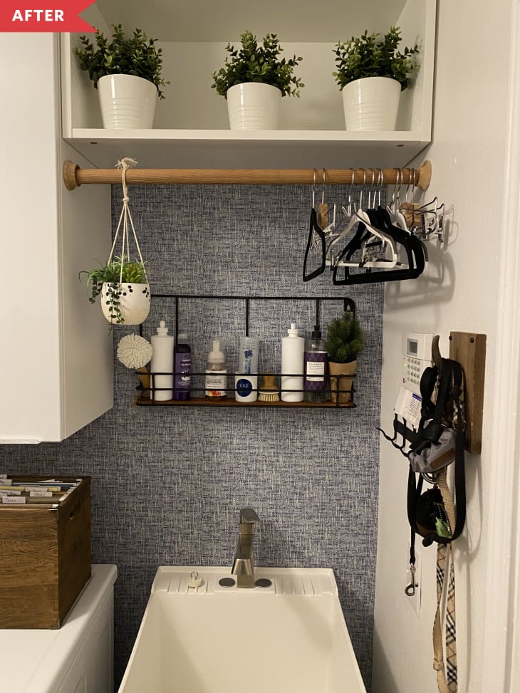 After: Laundry room sink with blue wallpaper and shelves above a utility sink