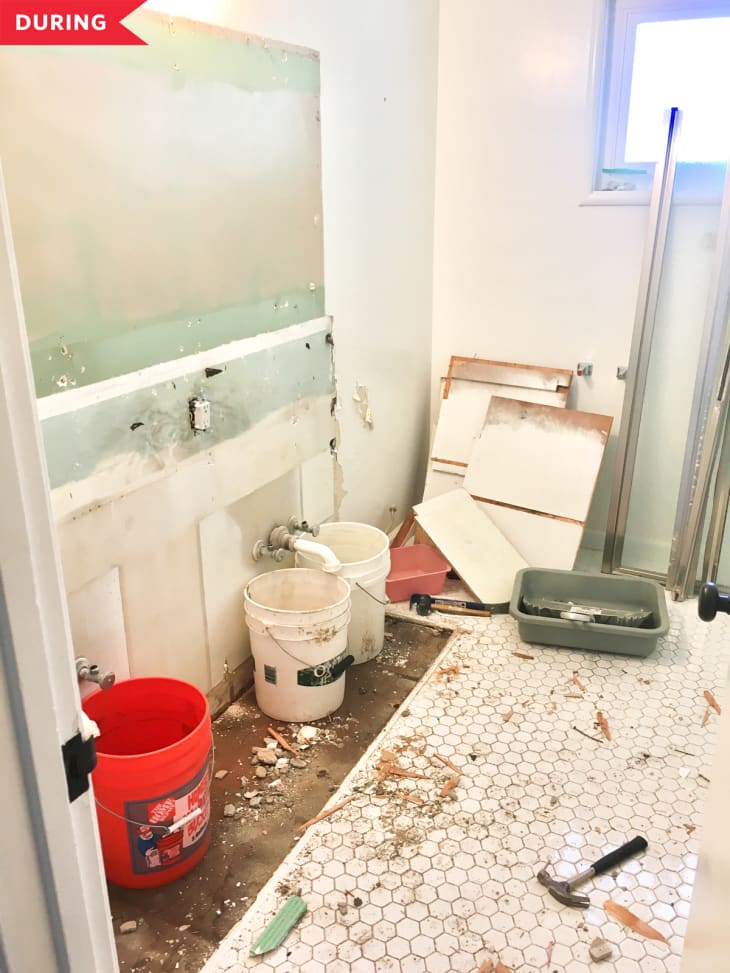 During: Mid-demolition, with vanity and old tile removed