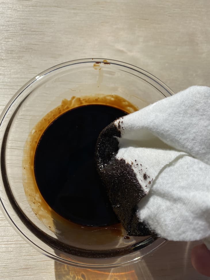 white cloth dipping into a glass bowl full of coffee stain