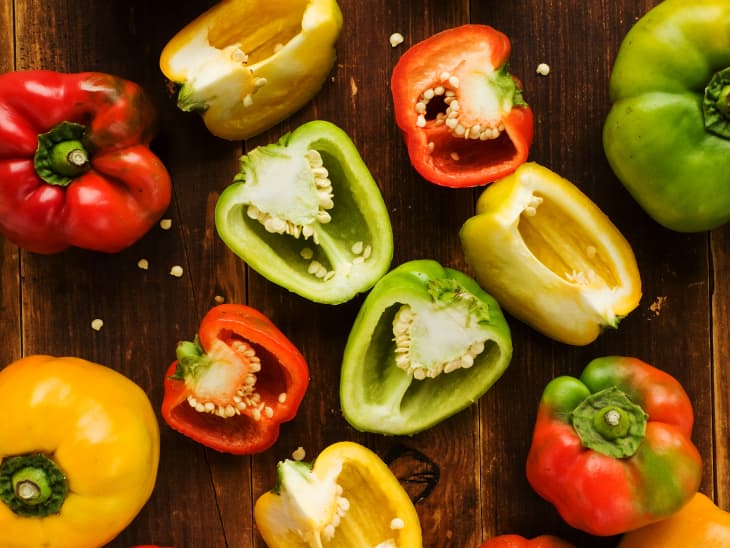Group of colorful peppers on the wooden background. Viewed from above.