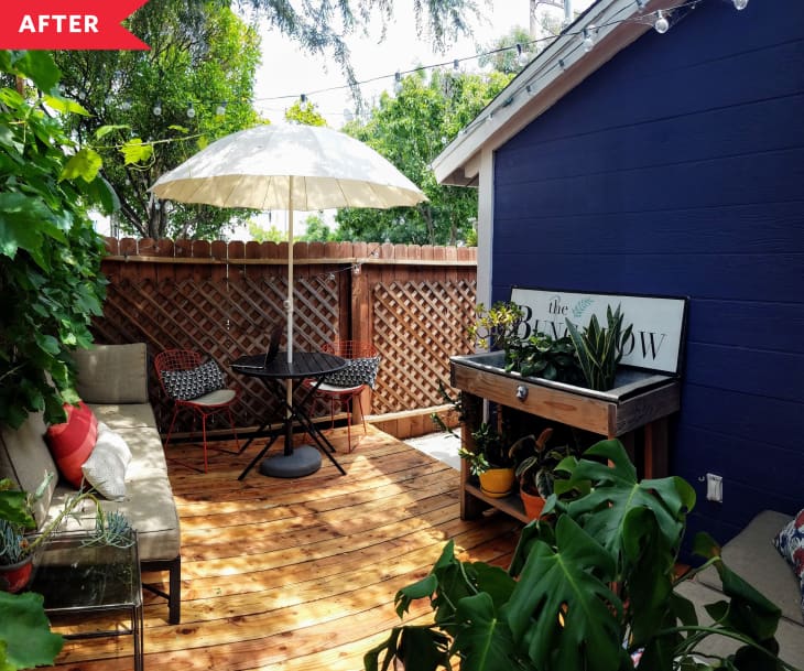 After: backyard with fresh wood deck, furniture, and fencing