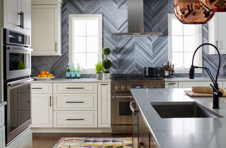 white kitchen with gray backsplash in a chevron pattern