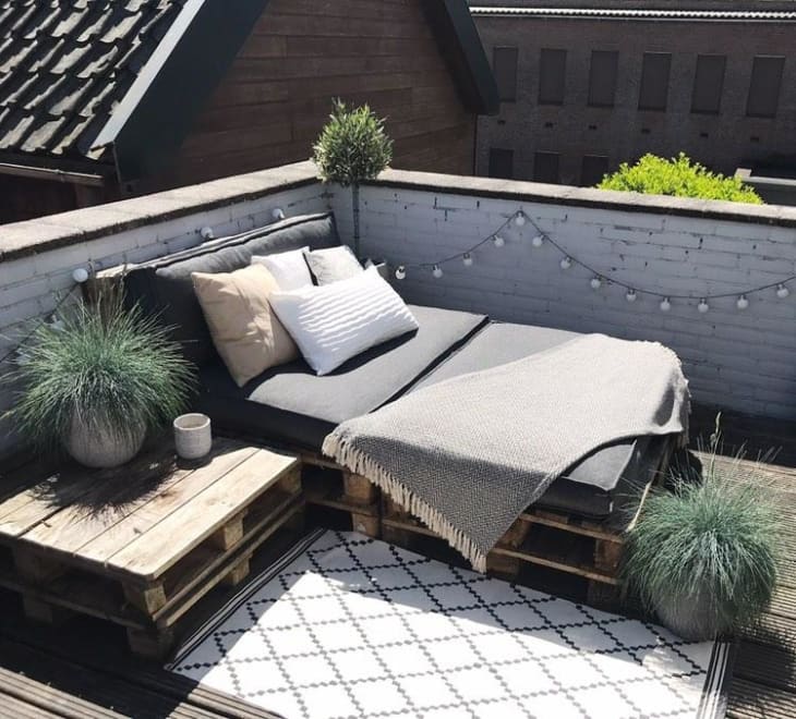 Scandi-style pallet daybed on open rooftop