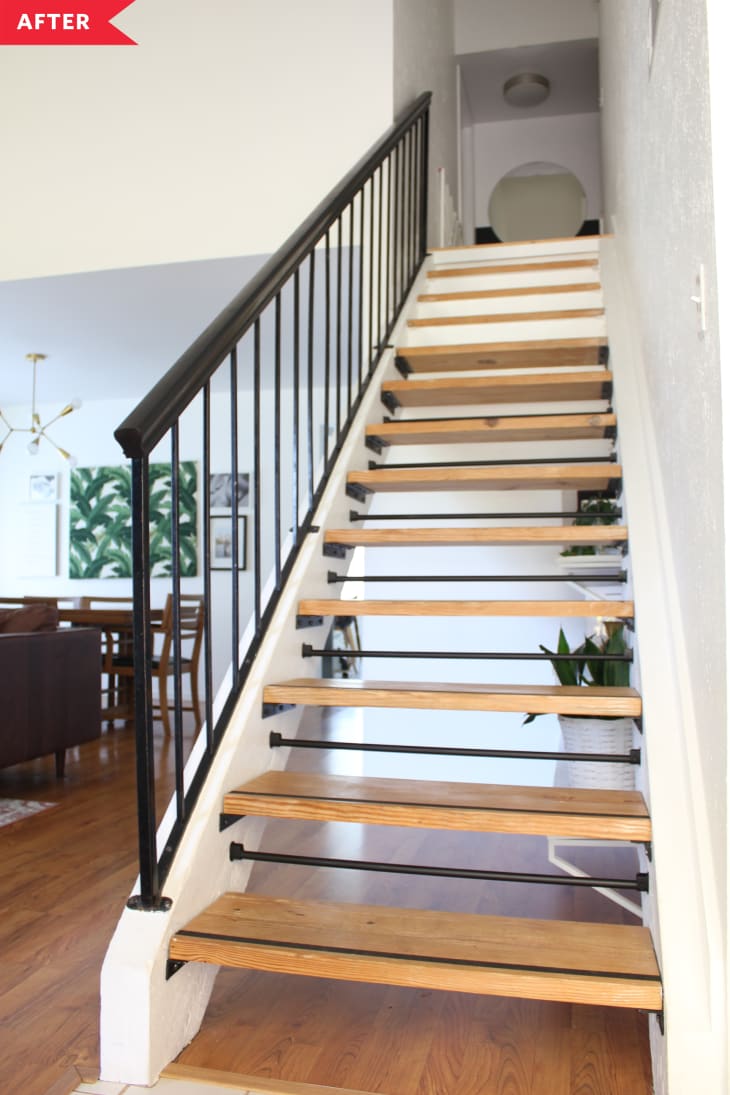 After: Open staircase with black railing and wood treads.