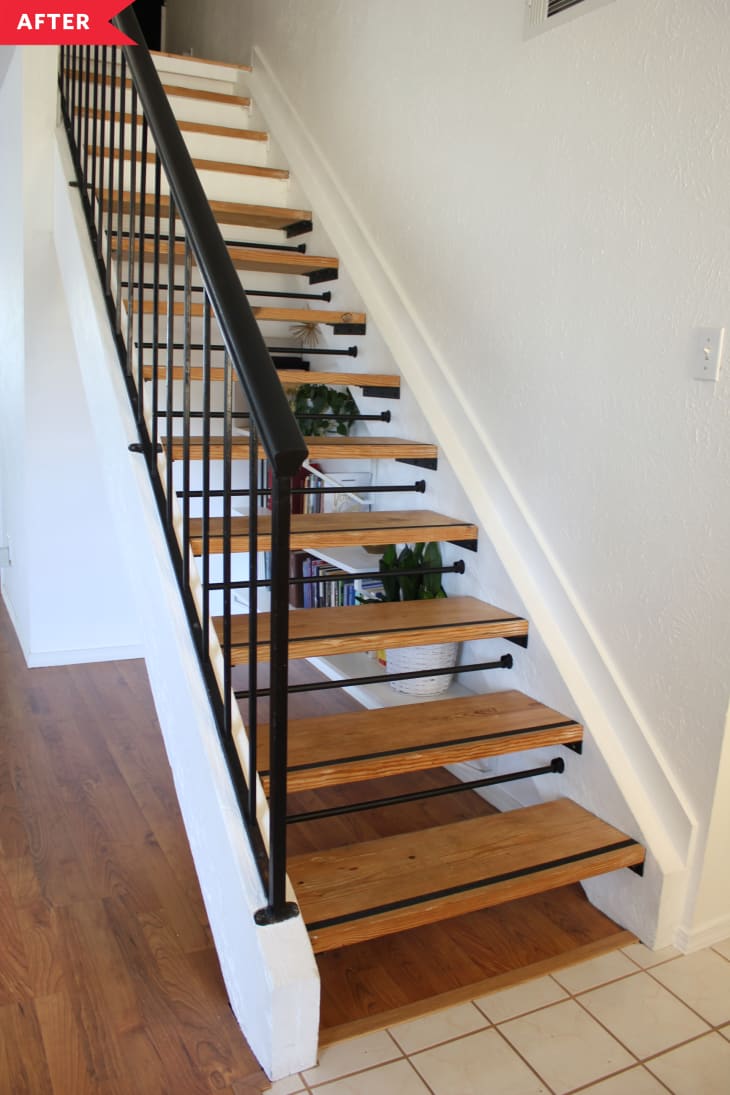 After: Open staircase with black railing and wood treads.