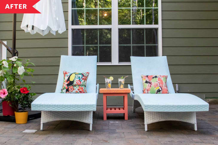 after: White and blue lounge chairs with orange side table, umbrella, and potted flowers