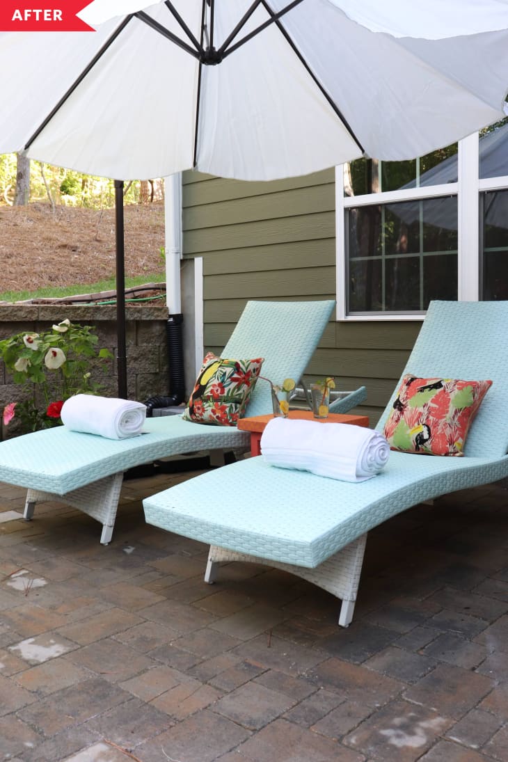 after: White and blue lounge chairs with orange side table, umbrella, and potted flowers