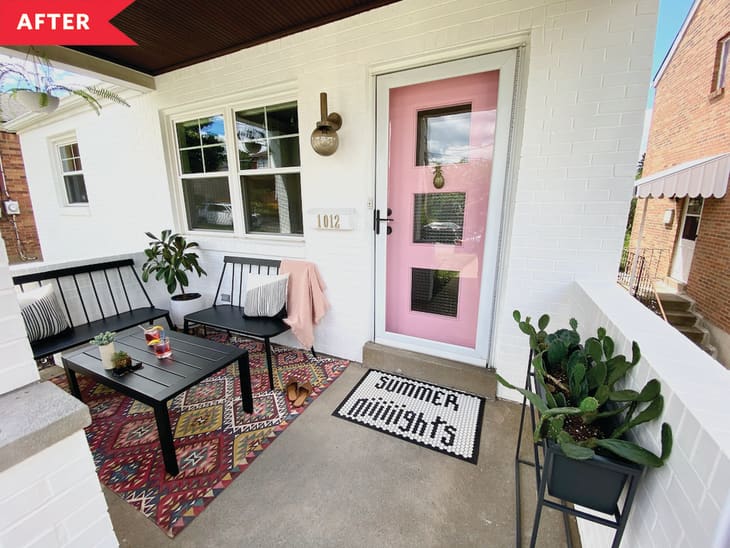 After: Porch with black furniture, pink door, and various decor