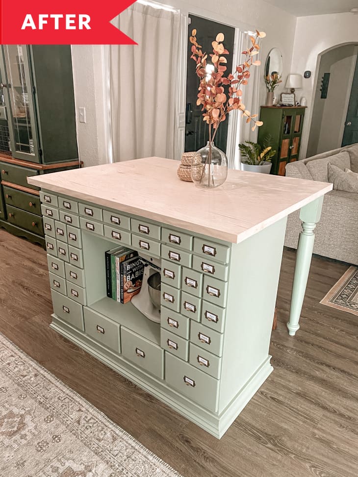 After: Seafoam kitchen island with many drawers and marble countertop