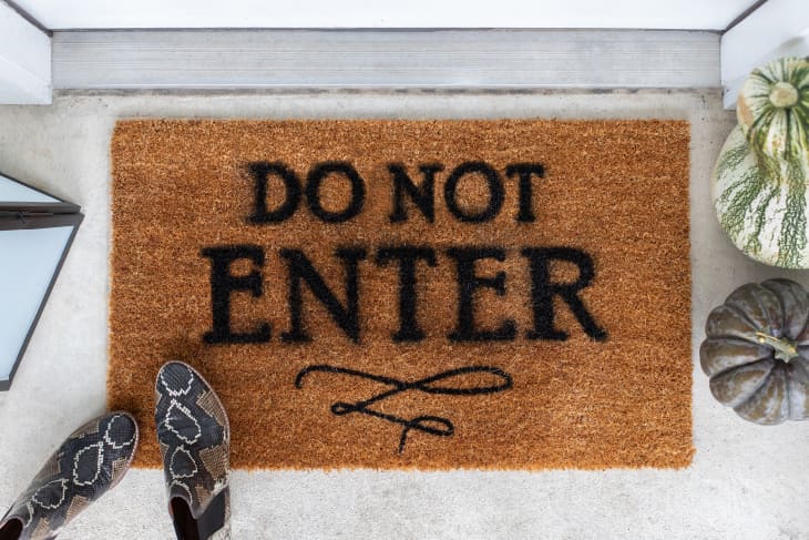 Brown doormat with phrase "do not enter" written in black