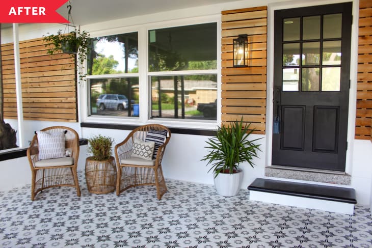 After: mid-century style entry with black and white patterned floor, white siding, wood panels, and black door
