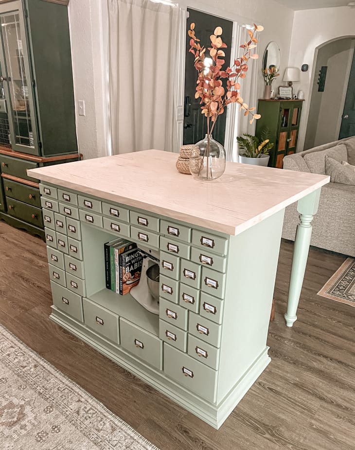 Pale green desk with drawers that's been made into a kitchen island