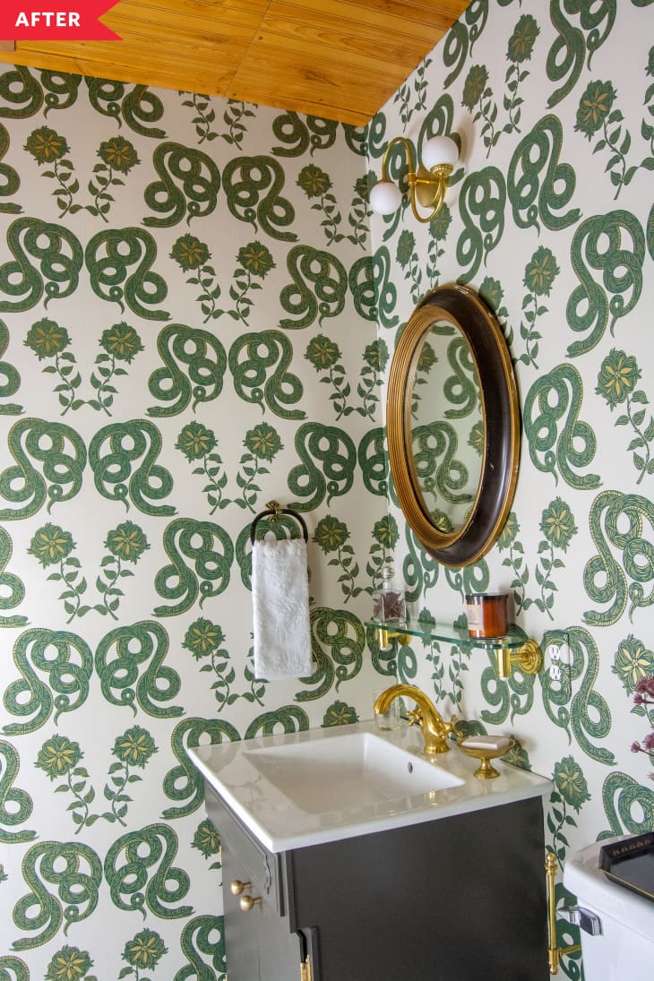 After: Bathroom with green and white snake wallpaper, wood ceiling, and gray vanity
