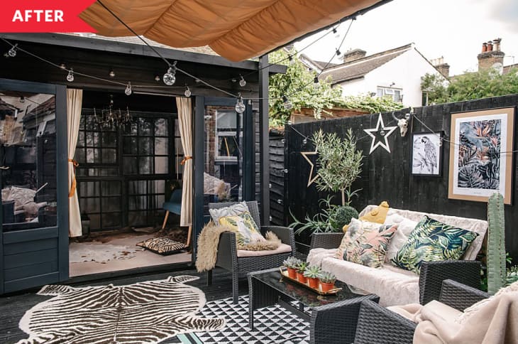 After: Patio painted black and accessorized with string lights, zebra rug and more.