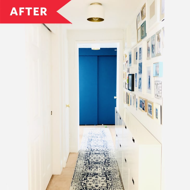 After: Bright, cheery hallway with gallery wall, rug, and blue wall at end