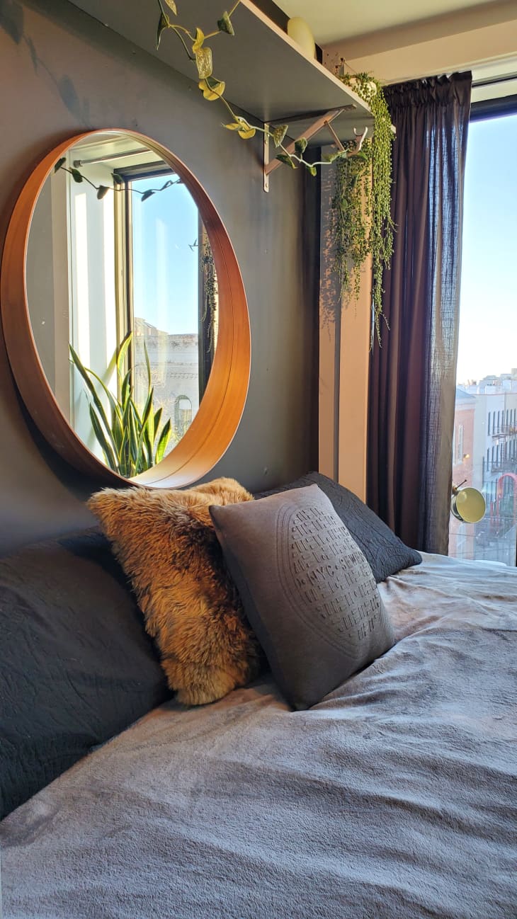 Bed with round mirror above