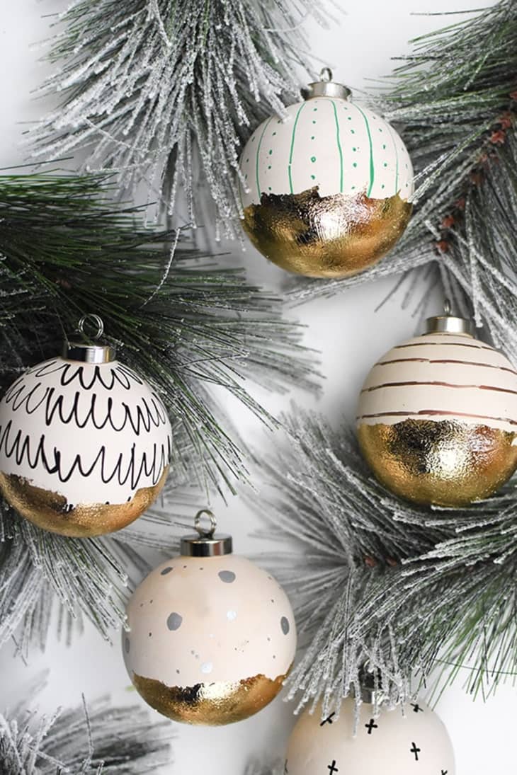 Off-white ball ornaments decorated with gold leafing pen