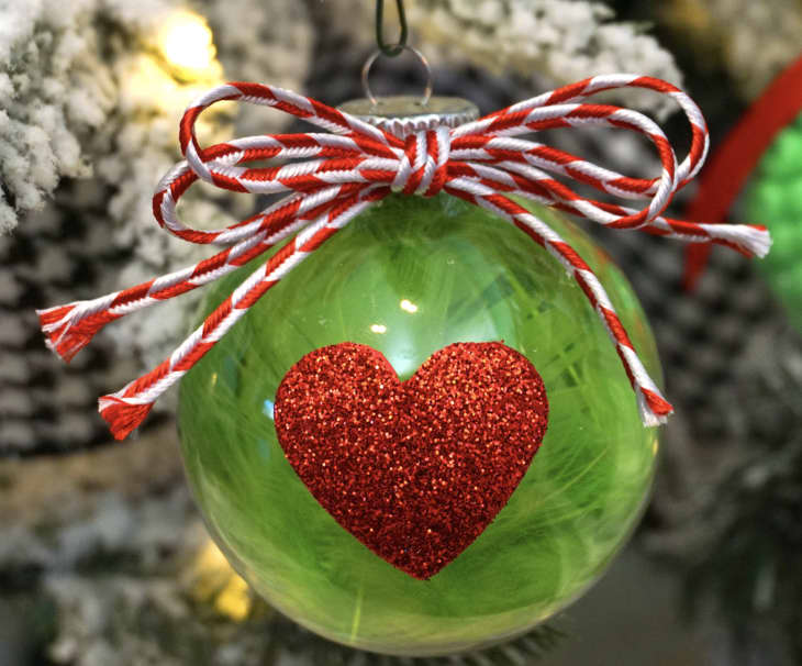 Green ornament with red heart in center
