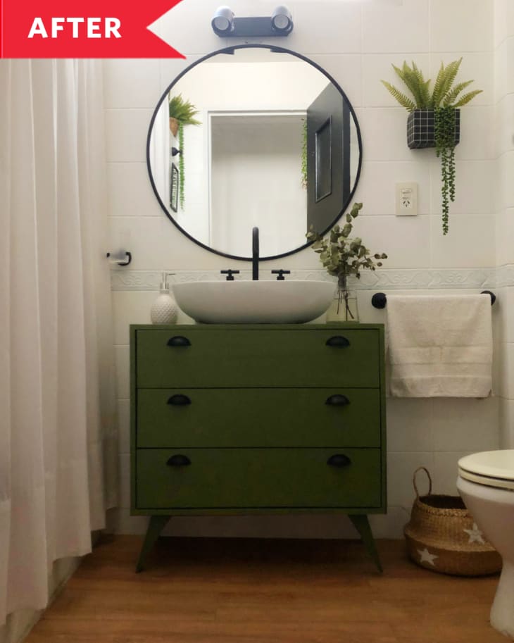 After: Bathroom with circular mirror and green vanity