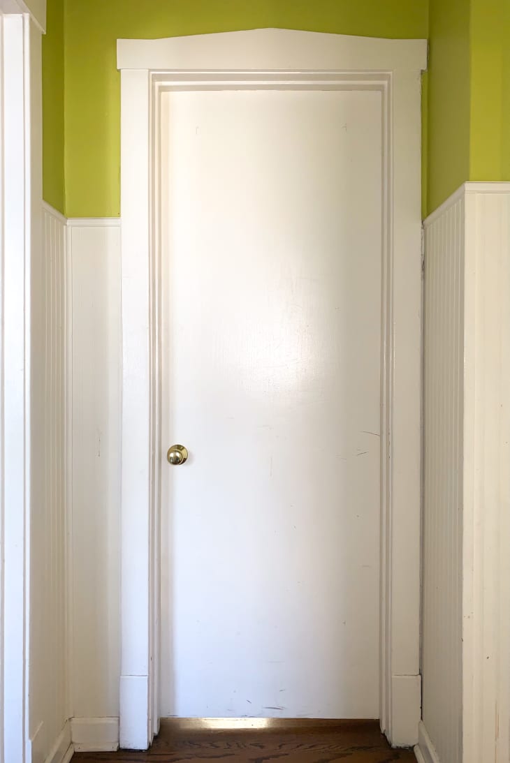 Before: plain white door against a white and green wall