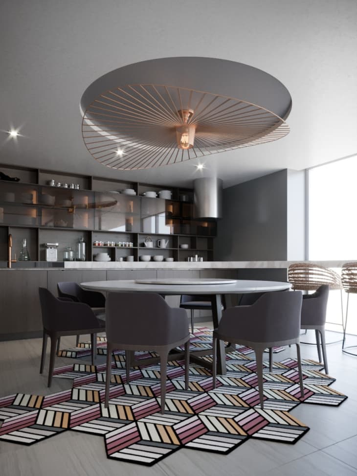 Kitchen with gray tones, colorful geometric rug, and circular light fixture