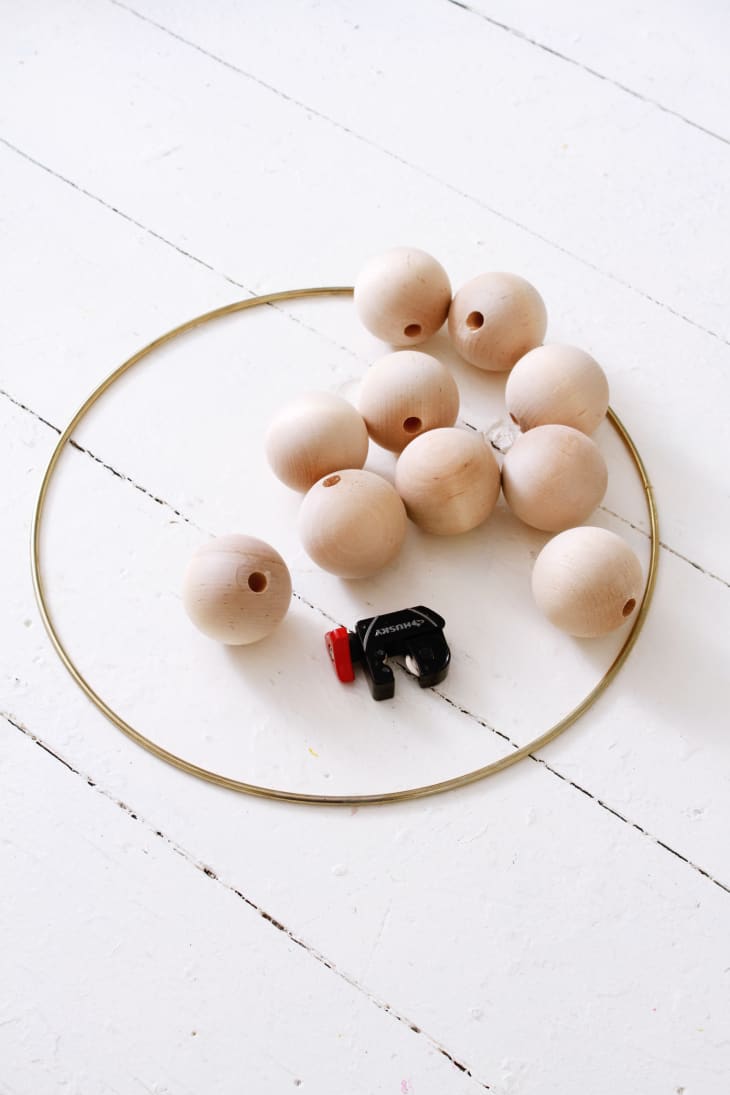 Materials for Scandi wreath, including metal hoop, wood beads, and tube cutter