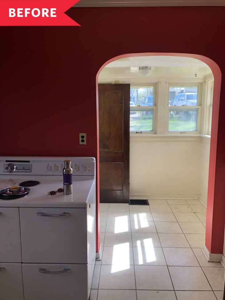 Before: Arched entryway in outdated kitchen with red walls