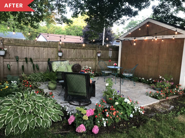 After: Patio made with brick pavers, surrounded with flowers and filled with seating