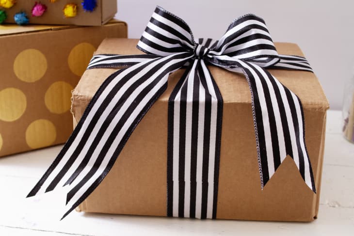 brown cardboard box with a black and white ribbon
