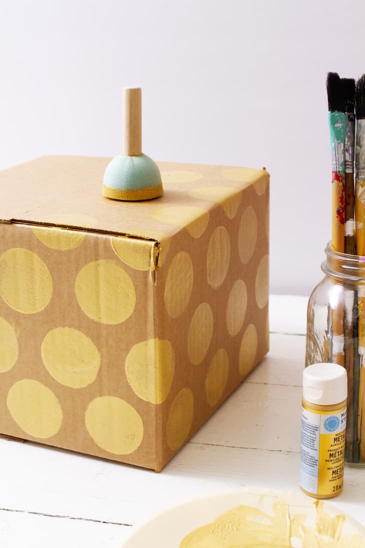 stamping box with yellow painted circles