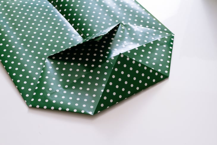 folding paper triangles into center of bag bottom