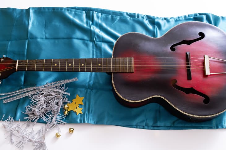 guitar laid on top of the pillowcase