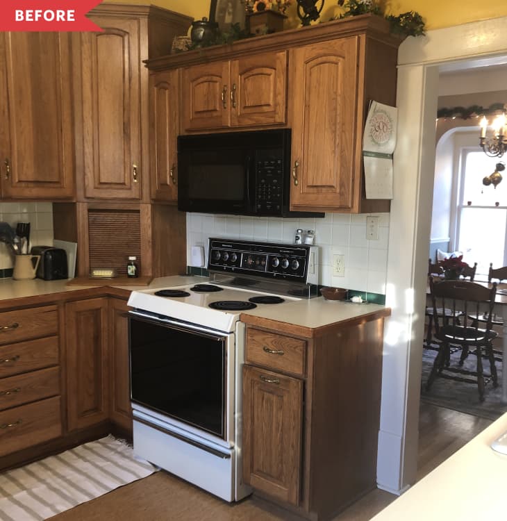 Before: Brown wood kitchen cabinets with dated range
